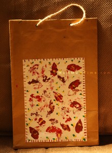 Gift bag done with colorful stamps using a leaf