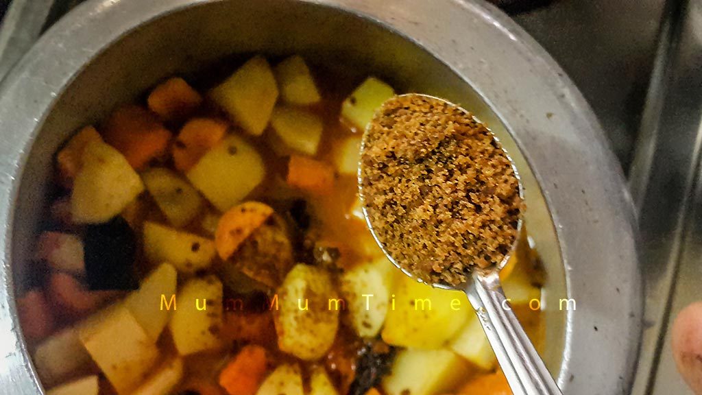 Adding Jaggery to Potato Carrot Sabzi
